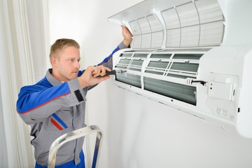 Mechanic repairing AC indoor unit