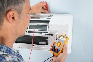 Mechanic repairing AC indoor unit