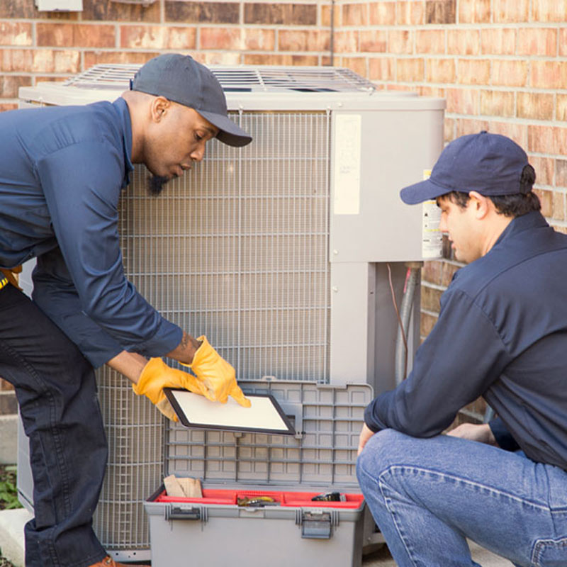 HVAC techs repairing ac unit