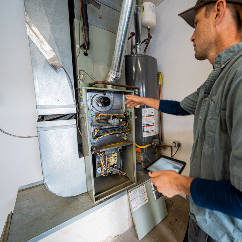 man repairing furnace
